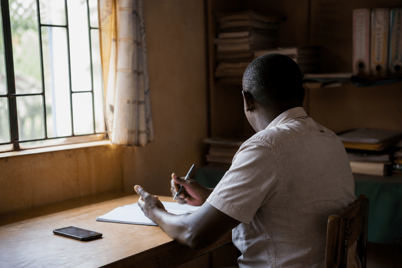 Quiet desk with phone and notebook suggesting confidential family guidance